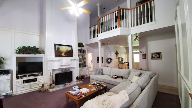 living room featuring ceiling fan and a towering ceiling