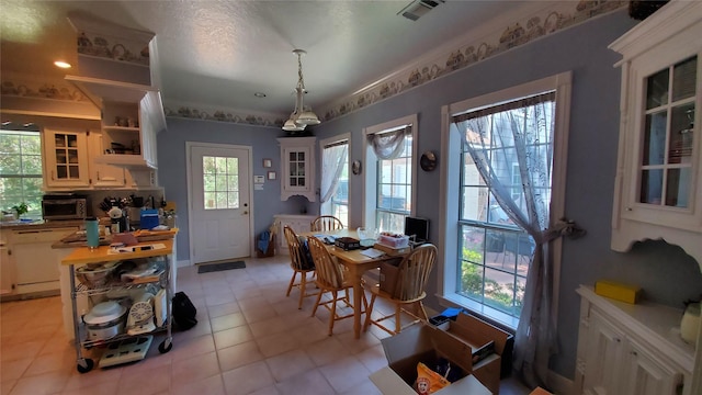 dining area with light tile flooring and a healthy amount of sunlight