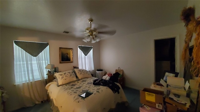 bedroom with ceiling fan and multiple windows