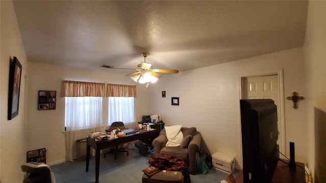 carpeted living room featuring ceiling fan