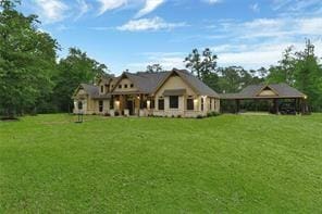 back of house featuring a yard and a gazebo