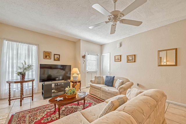 tiled living room featuring ceiling fan and a textured ceiling