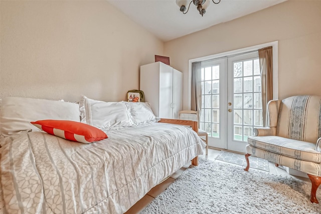 tiled bedroom with access to exterior, lofted ceiling, and french doors