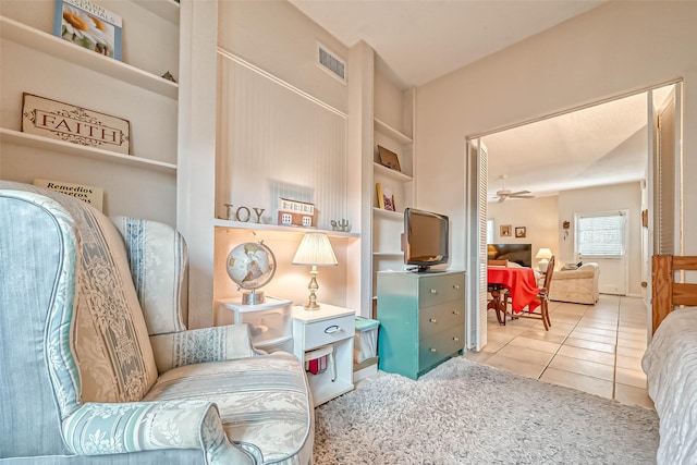 sitting room with ceiling fan, tile patterned floors, and built in features