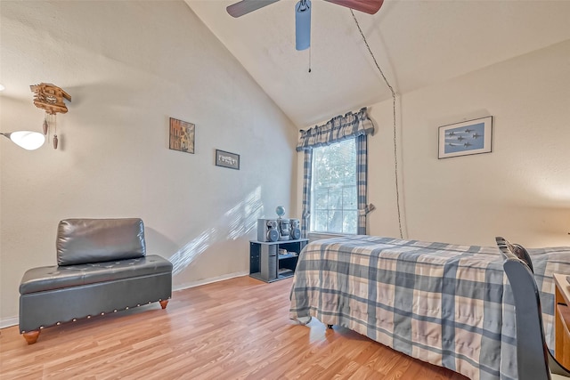 bedroom featuring ceiling fan, light hardwood / wood-style floors, and high vaulted ceiling