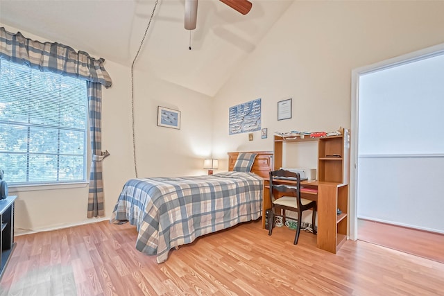 bedroom featuring ceiling fan, hardwood / wood-style flooring, and high vaulted ceiling