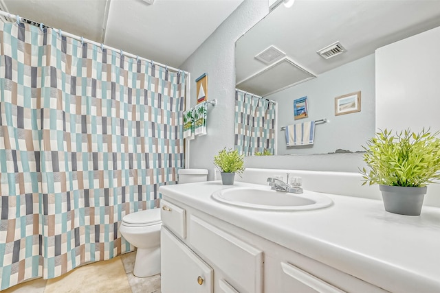 bathroom featuring toilet, tile patterned floors, and vanity