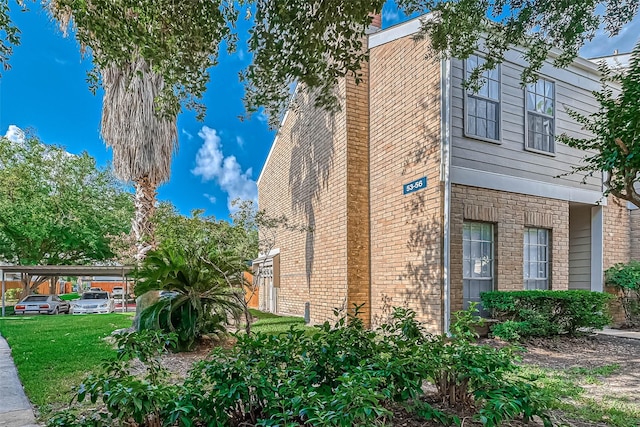 view of side of home with a lawn