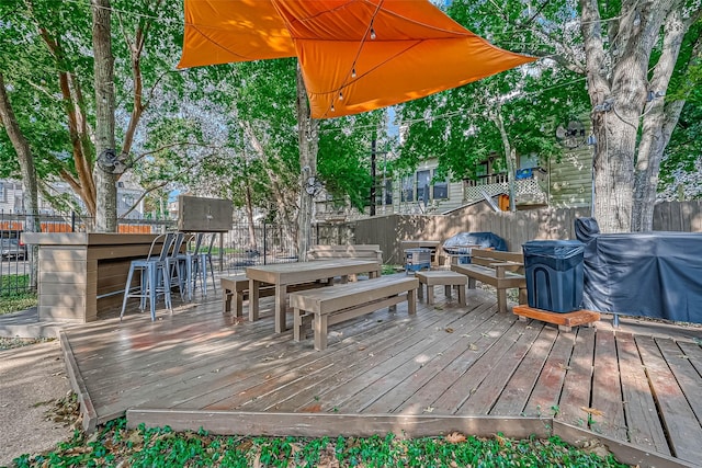 wooden terrace featuring a bar