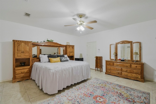 tiled bedroom featuring ceiling fan