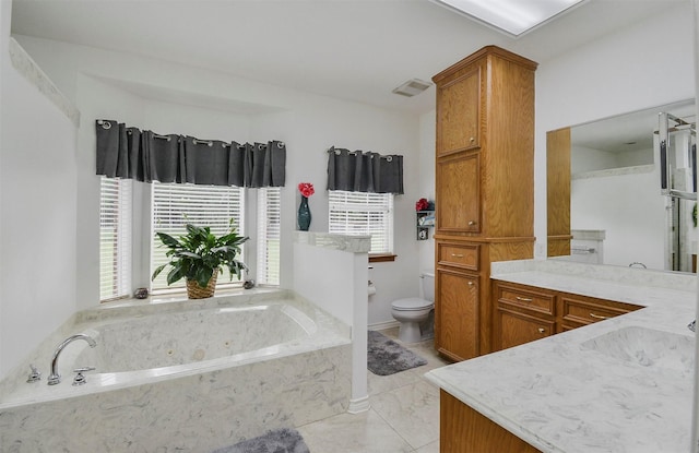 bathroom with vanity, tile flooring, toilet, and tiled tub