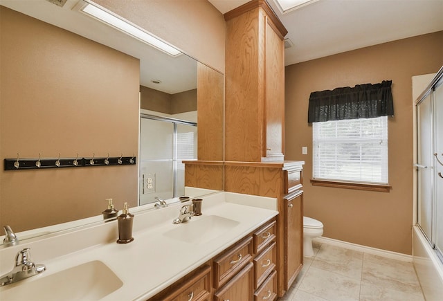 full bathroom featuring toilet, combined bath / shower with glass door, tile flooring, and double vanity