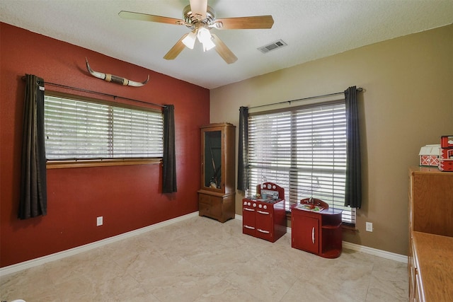 miscellaneous room with ceiling fan and light tile flooring