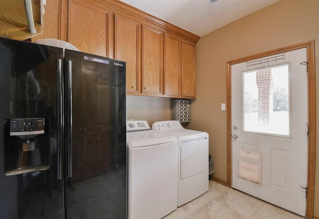 washroom featuring washing machine and clothes dryer, cabinets, and light tile floors