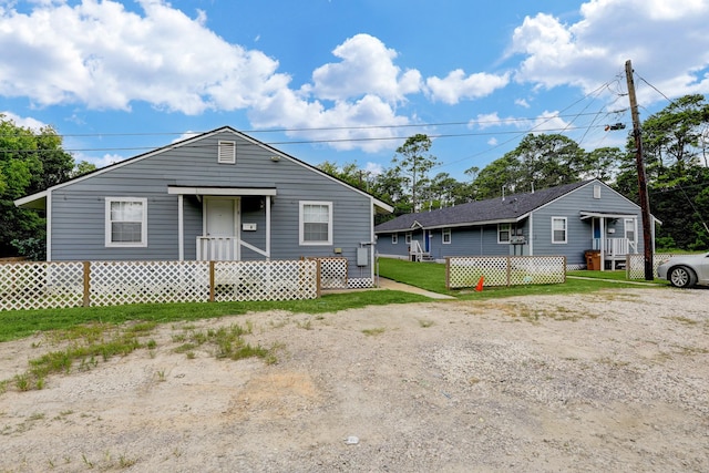 bungalow-style home with a front yard