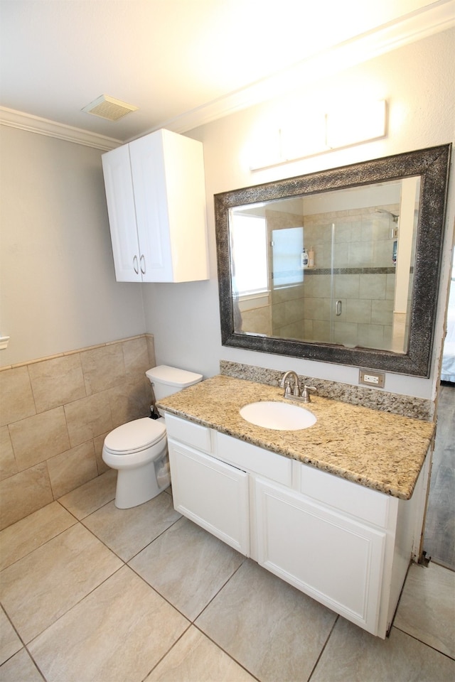 bathroom featuring vanity, tile flooring, toilet, and ornamental molding