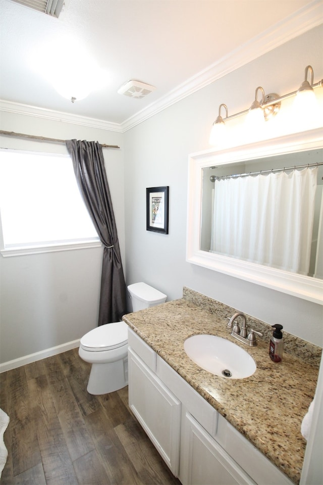 bathroom with crown molding, toilet, wood-type flooring, and vanity