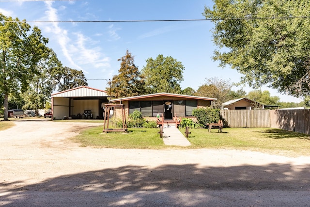 view of front of property with a front yard and a carport