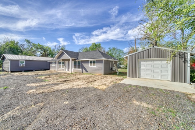 single story home featuring an outdoor structure and a garage