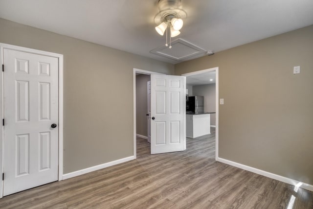 unfurnished room with ceiling fan and hardwood / wood-style flooring