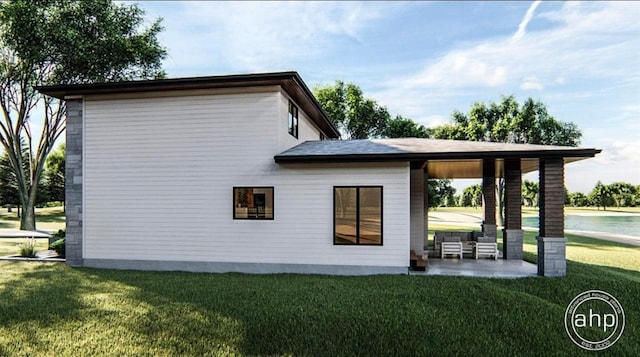 rear view of house featuring a lawn and a patio