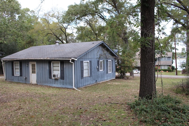 view of side of property with a yard