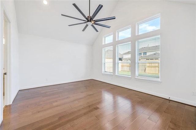 empty room with ceiling fan, dark hardwood / wood-style floors, and plenty of natural light