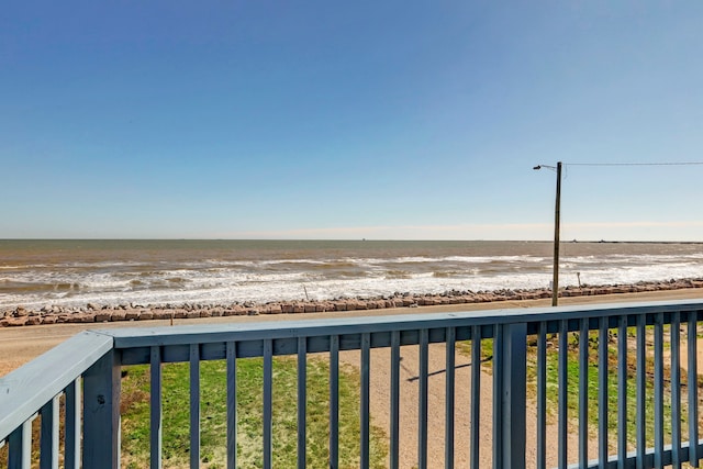 view of yard featuring a beach view and a water view