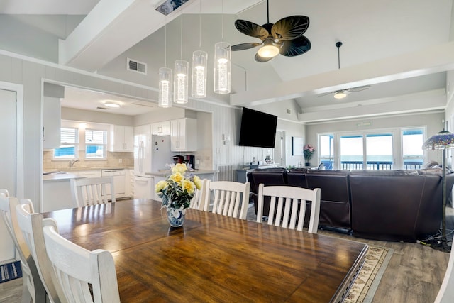 dining room featuring ceiling fan, light hardwood / wood-style flooring, sink, and a healthy amount of sunlight