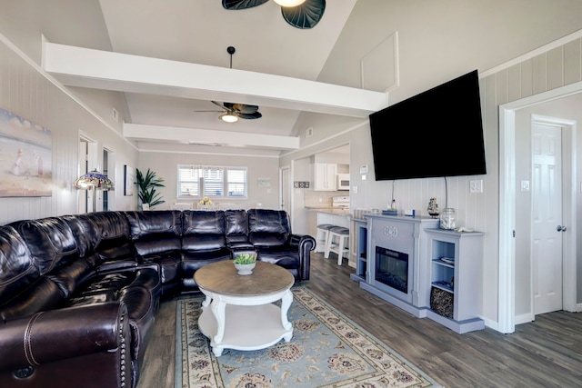 living room featuring ceiling fan, vaulted ceiling, and dark hardwood / wood-style flooring