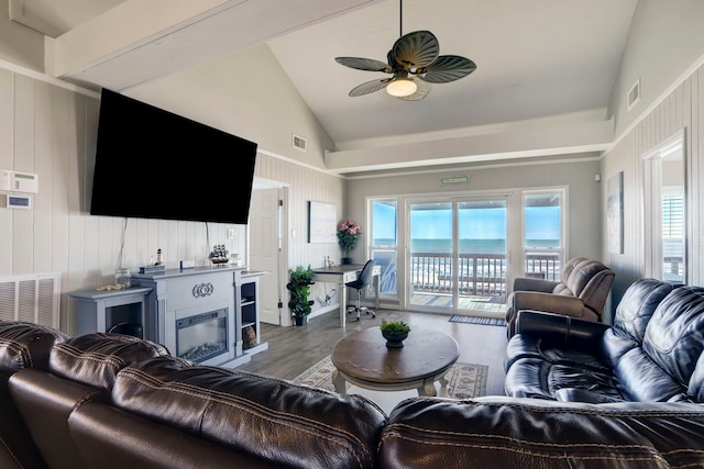 living room featuring vaulted ceiling, dark hardwood / wood-style flooring, and ceiling fan