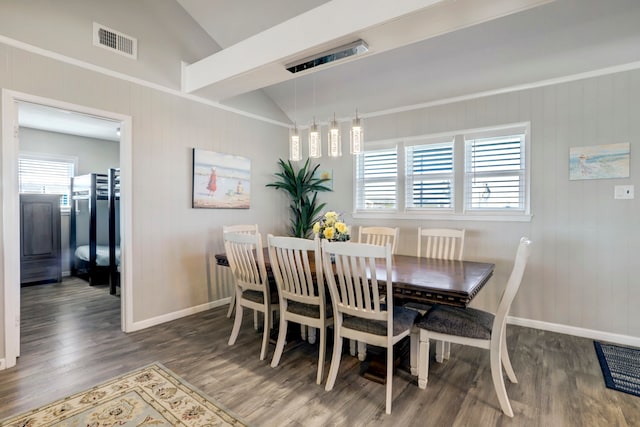 dining area with vaulted ceiling with beams and dark wood-type flooring