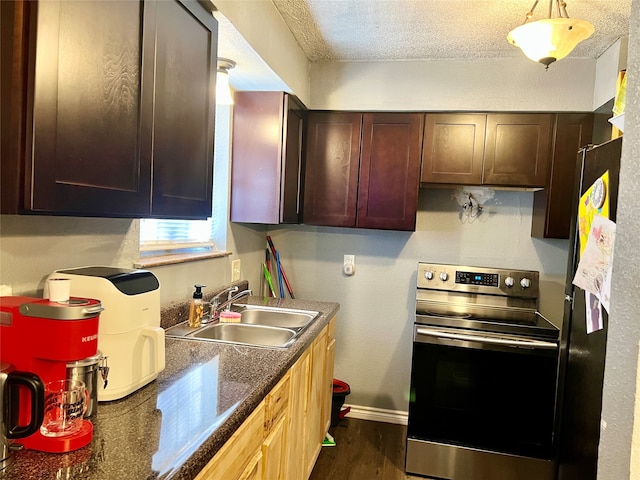 kitchen featuring stainless steel electric range oven, sink, a textured ceiling, dark brown cabinetry, and dark hardwood / wood-style flooring