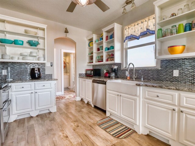 kitchen with ceiling fan, backsplash, white cabinets, and dishwasher