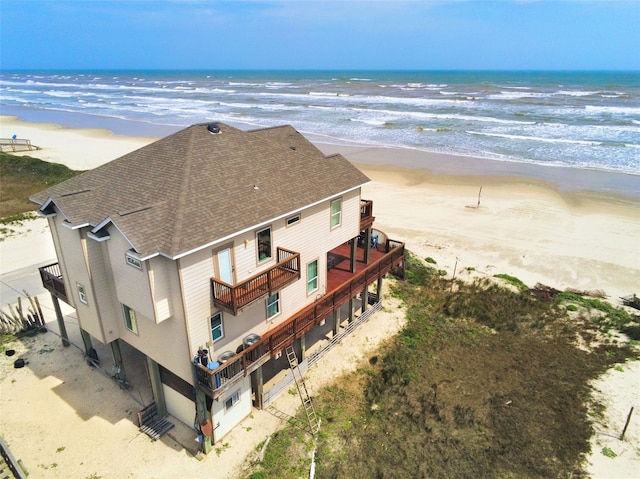 bird's eye view featuring a water view and a beach view