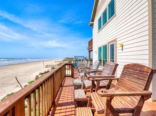 deck with a beach view and a water view