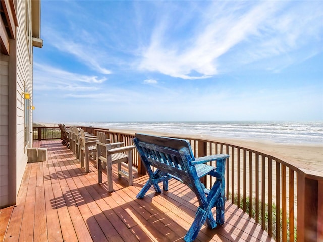 deck featuring a view of the beach and a water view