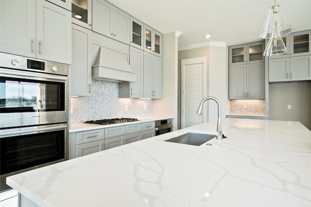 kitchen featuring tasteful backsplash, custom exhaust hood, stainless steel double oven, and light stone counters