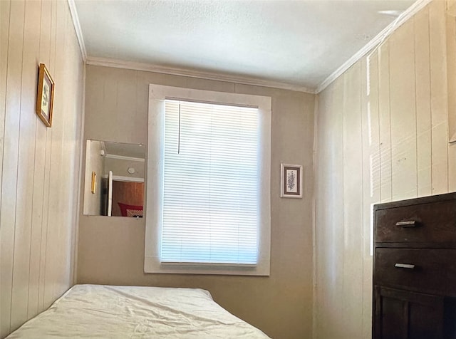 bedroom with crown molding and multiple windows