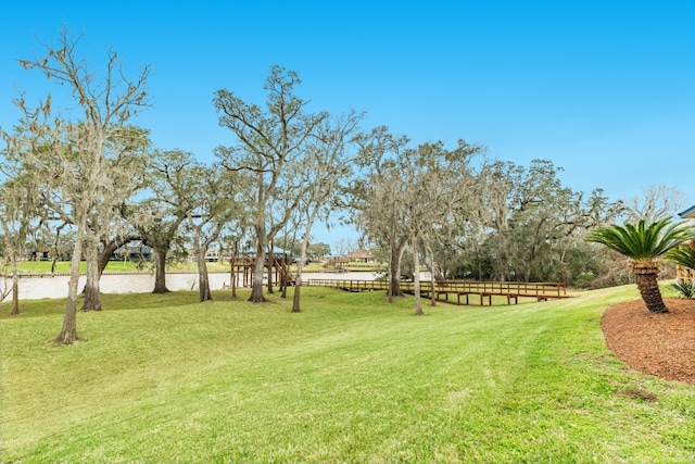 view of property's community with a lawn