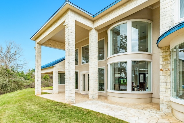 rear view of house featuring a yard and a patio area