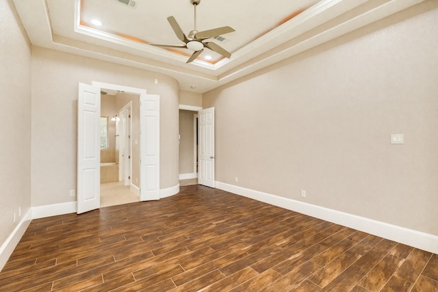 unfurnished bedroom featuring ceiling fan, a raised ceiling, and dark wood-type flooring