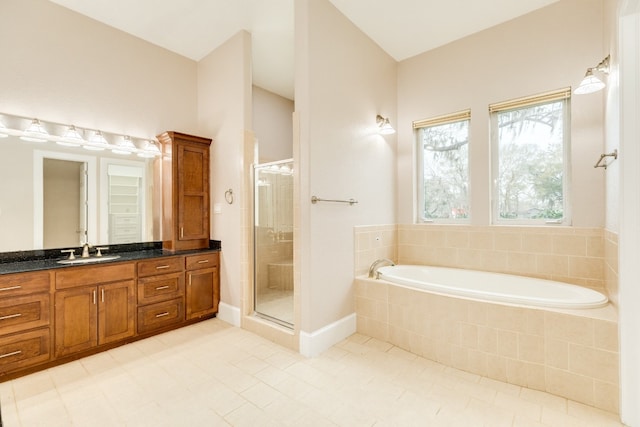 bathroom featuring plus walk in shower, tile floors, and vanity