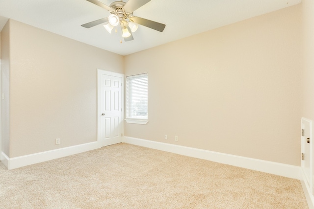 spare room featuring light carpet and ceiling fan