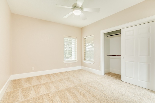 unfurnished bedroom featuring light carpet, a closet, and ceiling fan