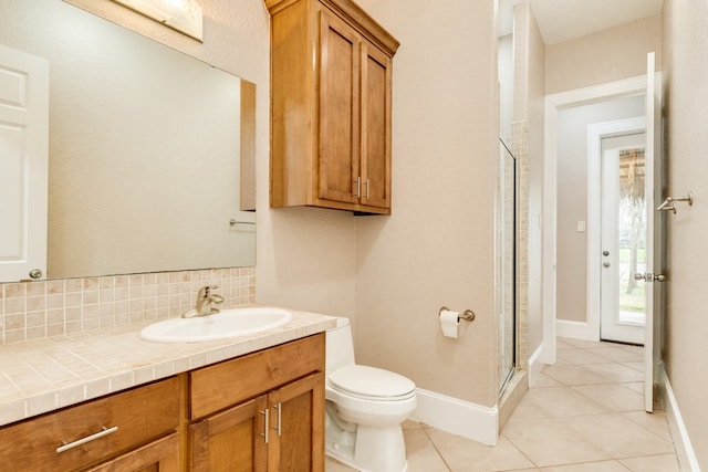 bathroom featuring toilet, tile flooring, walk in shower, and vanity