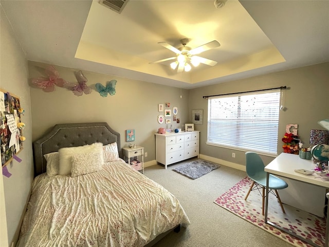 9822 Samantha Suzanne Ct, Houston, TX 77025 - carpeted bedroom with a tray ceiling and ceiling fan
