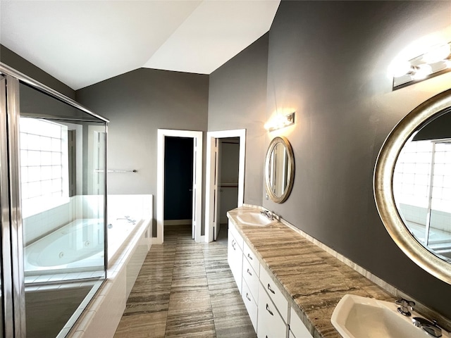9822 Samantha Suzanne Ct, Houston, TX 77025 - bathroom with dual sinks, oversized vanity, a relaxing tiled bath, tile flooring, and lofted ceiling