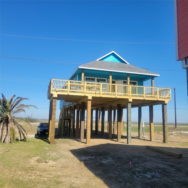 view of front facade featuring a wooden deck and a carport