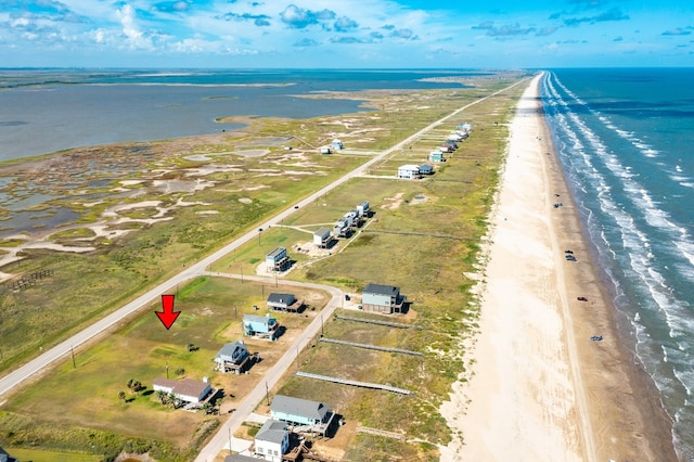 birds eye view of property featuring a water view and a view of the beach